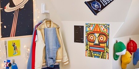Teenage bedroom showing wall décor and wall organisers including the Command folding clothes hanger
