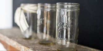 decorate Mason jars by tying ribbon