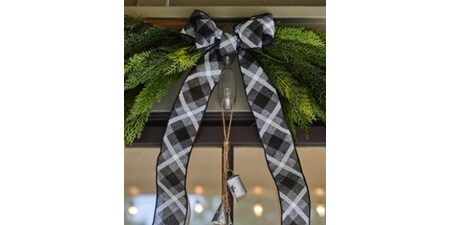 Layering different materials like ribbon and greenery add texture to this ornament.
