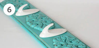 Board and tea towel hooks used for hanging kitchen hand towels
