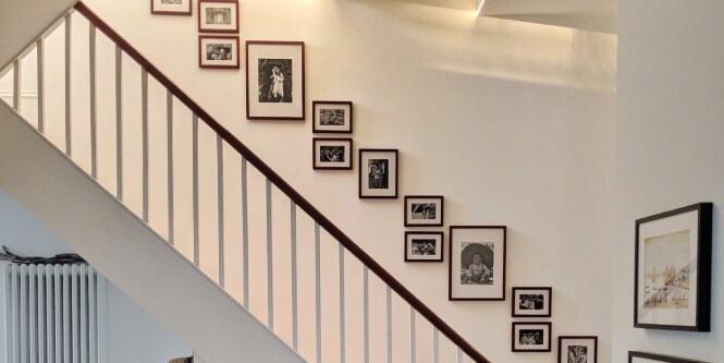 memory wall featuring picture frames by the staircase
