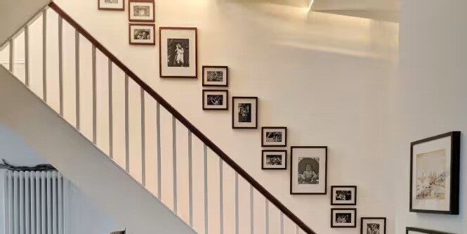 memory wall featuring picture frames by the staircase
