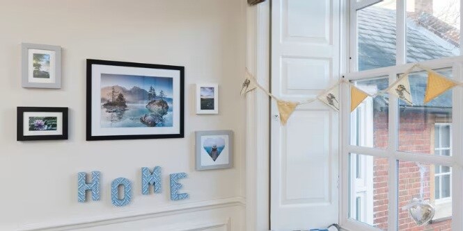 HOME cutouts displayed with picture hangers from Command™ Brand.
