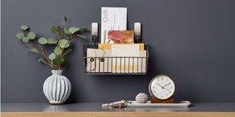 A caddy hung on Command metallic hooks to organise letters

