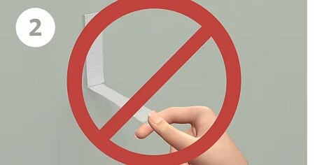 Step 2 of removing command strips - pull straight down on the strip; not pulling away from wall
