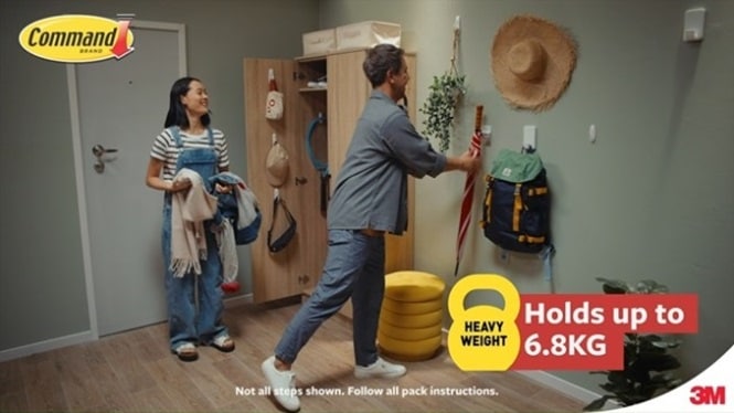 Various Command™ adhesive hooks are installed on the wall and in the closet to hang everyday items.
