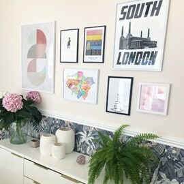 Creative gallery wall of posters, maps, and other pretty pictures – hung using Command™ Strips