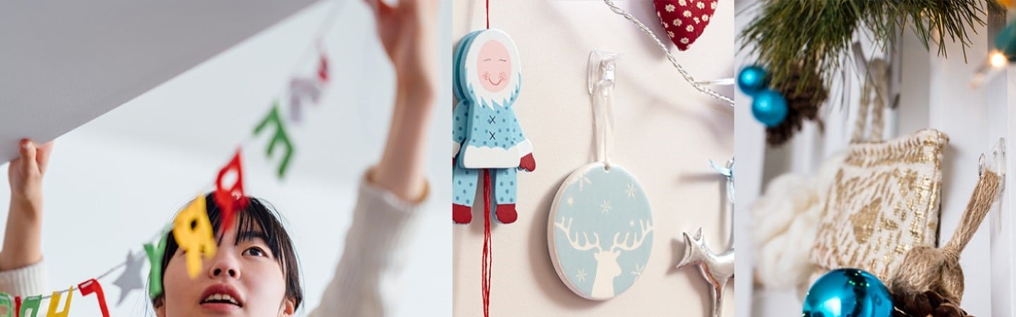 Christmas ornaments are displayed on the wall using Command clear mini hooks.
