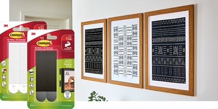 Large picture frames hung on the wall using Command x-large picture hanging strips
