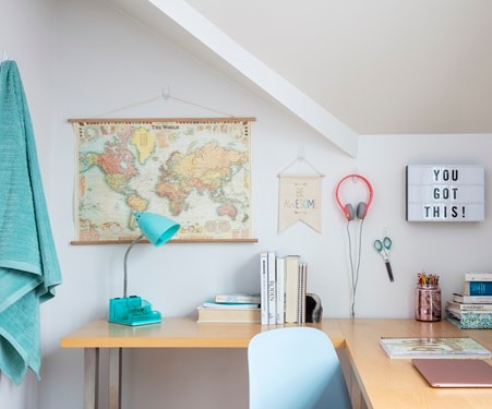 Study area inside the bedroom showing different items displayed on the wall using Command no-damage hangers
