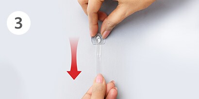 how to remove clear command hooks step3 - stretch strip slowly against the wall
