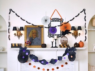 Decorate a Halloween-themed mantel by hanging garlands and paper medallions with no-drill Command™ Clear Decorating Clips and Clear Hooks.
