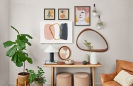 Artworks and mirrors hung on the wall using Command picture hanging strips