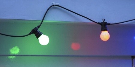 Colourful bulbs on the roof or gutter as Christmas  decorations, using Command as a gutter light clip
