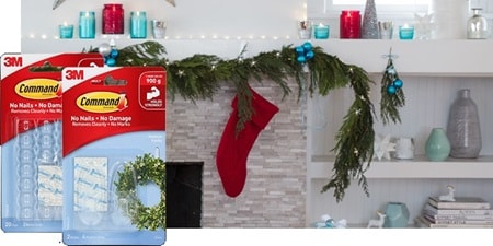 Garlands, stockings, and other Christmas wall hanging ornaments hung on the mantel with Command hooks
