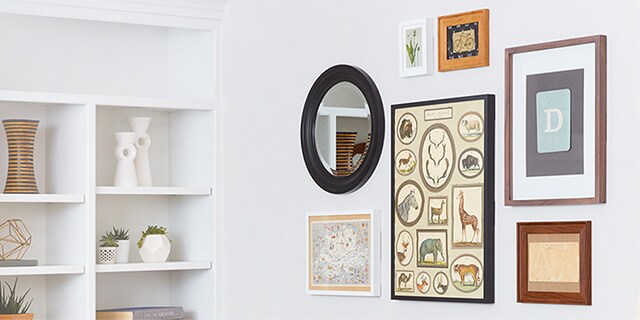 Mirrors, artwork, and framed photos displayed on the wall with command picture hanging strips