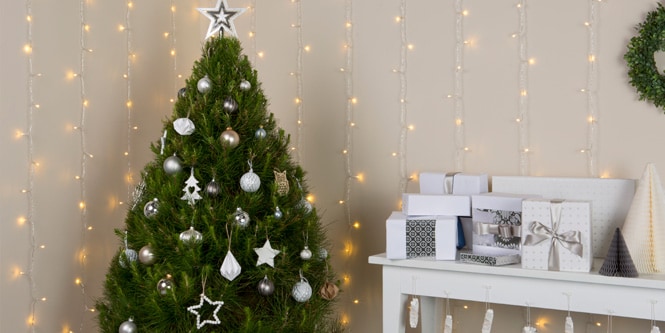 Christmas tree and hanging lights by the fireplace
