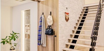 Bags, scarves, and caps arranged neatly  by the entrance door
