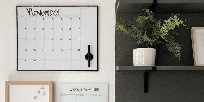 Family calendar and weekly planners displayed in the entryway
