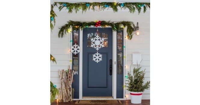 DIY snowflake decorations prettify this entrance for Christmas
