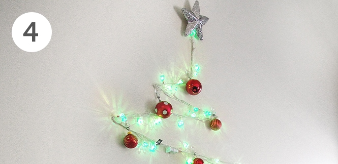DIY string light Christmas tree on wall
