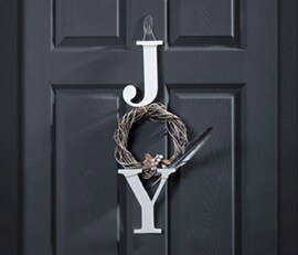JOY décor on the door, displayed with Command clear hook
