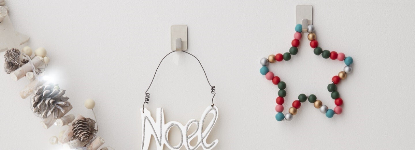 small Christmas decorations hung on the wall using Command metal decorative hooks
