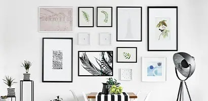A stylish wall collage composed of picture frames in various sizes using Command picture hanging strips.
