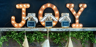 place decorative letters on top of the mantel