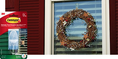 Hang a Christmas wreath on the exterior window glass using Command outdoor large clear window hook

