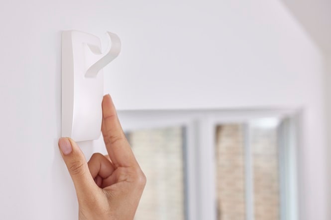 Use Command hooks to hang curtain rod without drilling
